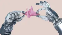 Two robot arms hold up a pink origami swan