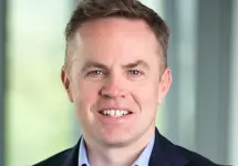 Alan Sinclair, UK Head of Energy and Natural Resources, in an office smiling in a suit