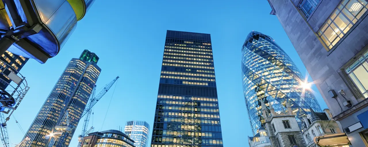 View of the London skyscrapers with the Gherkin shining the dark with offices lights beaming