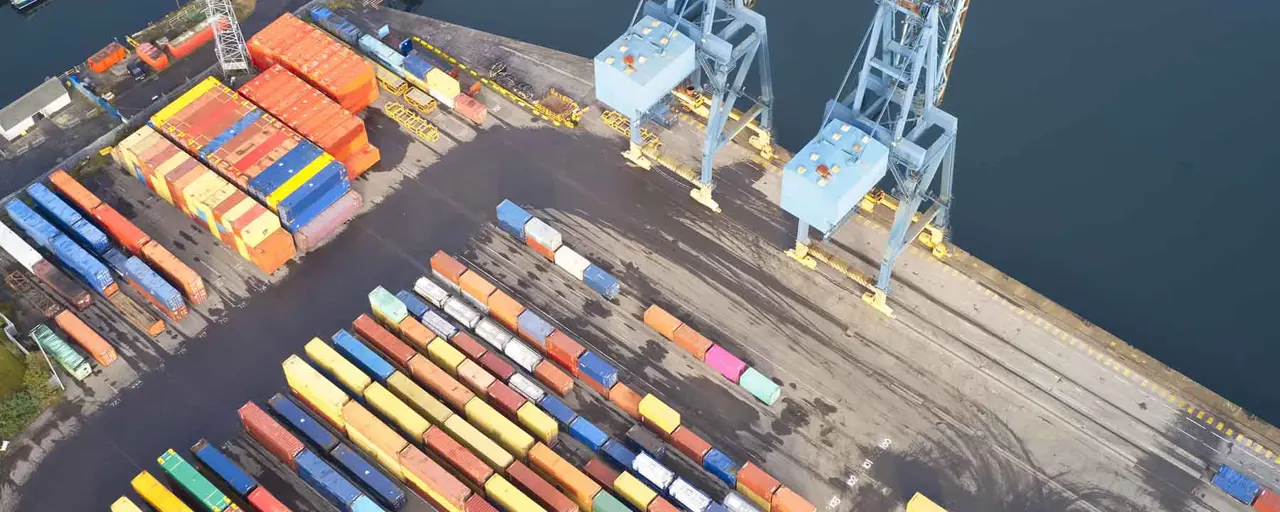 Birdseye view of colourful supply chain boxes on shipping doc