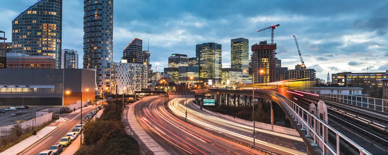 View of the city in the evening with flashing lights of the busy city passing by