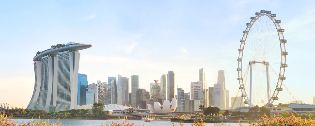 View of Singapore city with the sun beaming on the skyscraper and Singapore attractions.