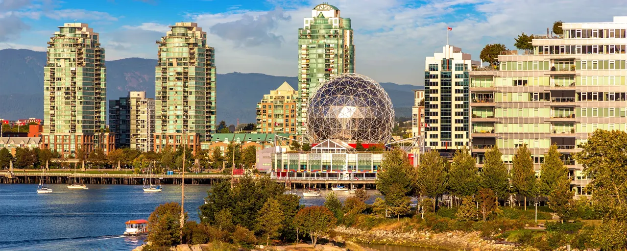 Canadian city on the coast with skyscrapers and a glass dome building