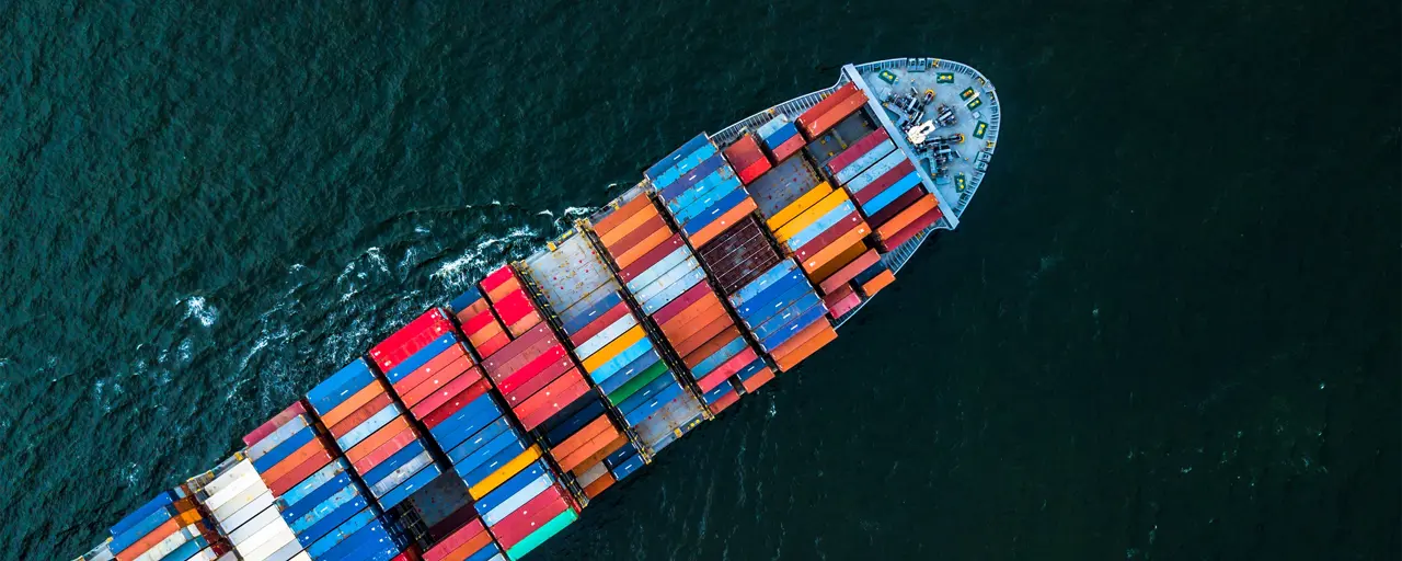 A freight ship with multi coloured containers at sea