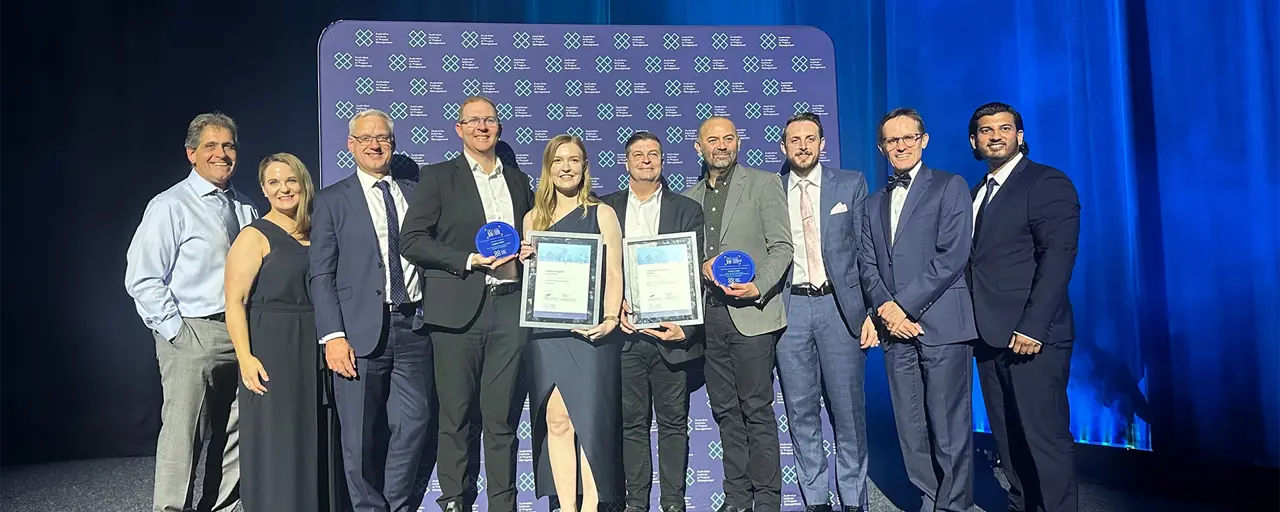 Group shot of award winners with awards