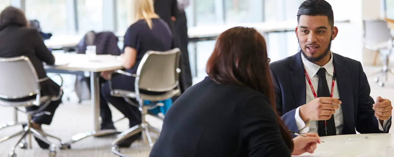 Male and female talking at office desk