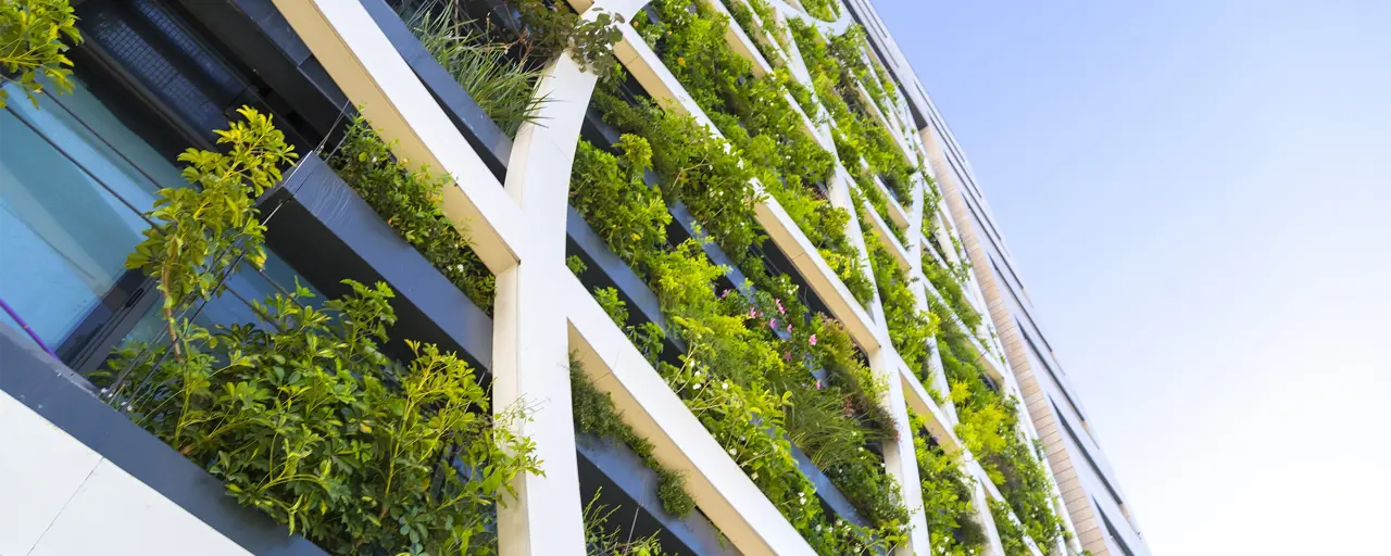 Exterior of tall building with green foliage