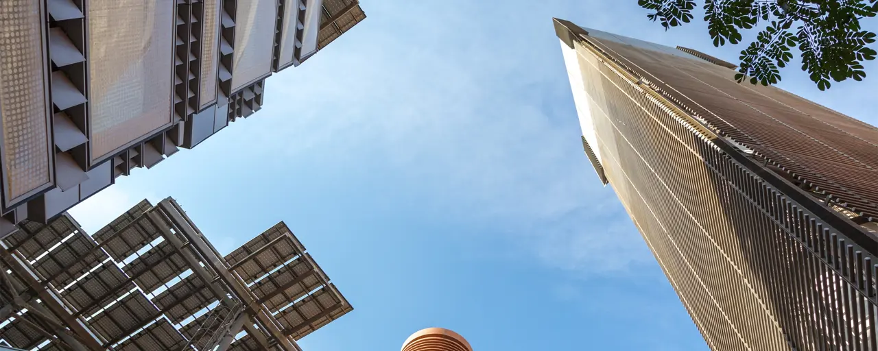 Upwards view of skyscraper buildings and blue sky