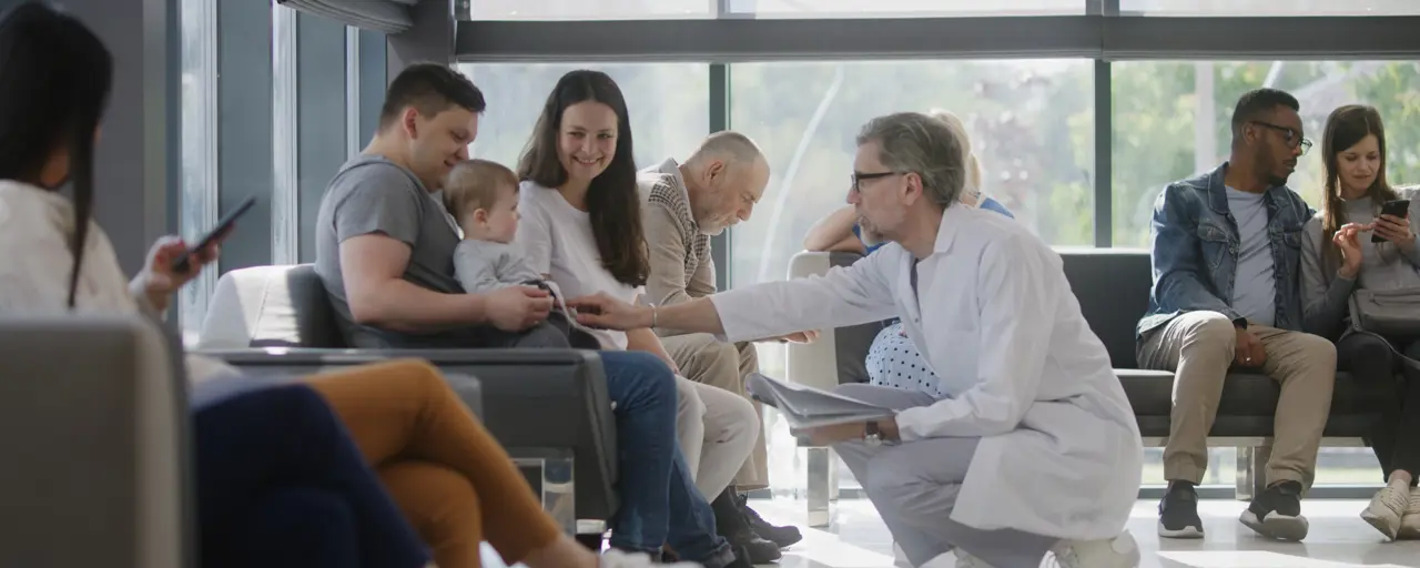 Doctor speaking to couple with baby in hospital