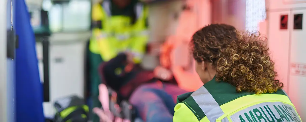 Interior of ambulance with two medics professionals and a patient on a stretcher