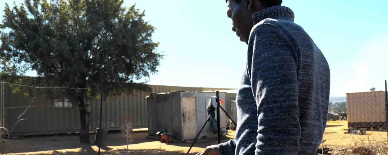 Man standing watering plants