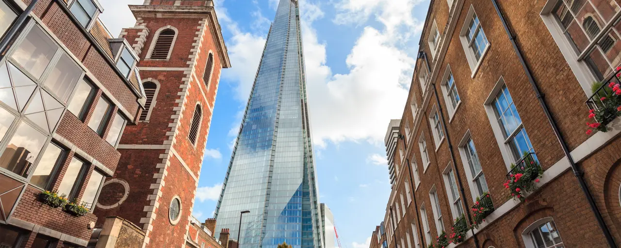 Tall brown buildings surrounding the Shard