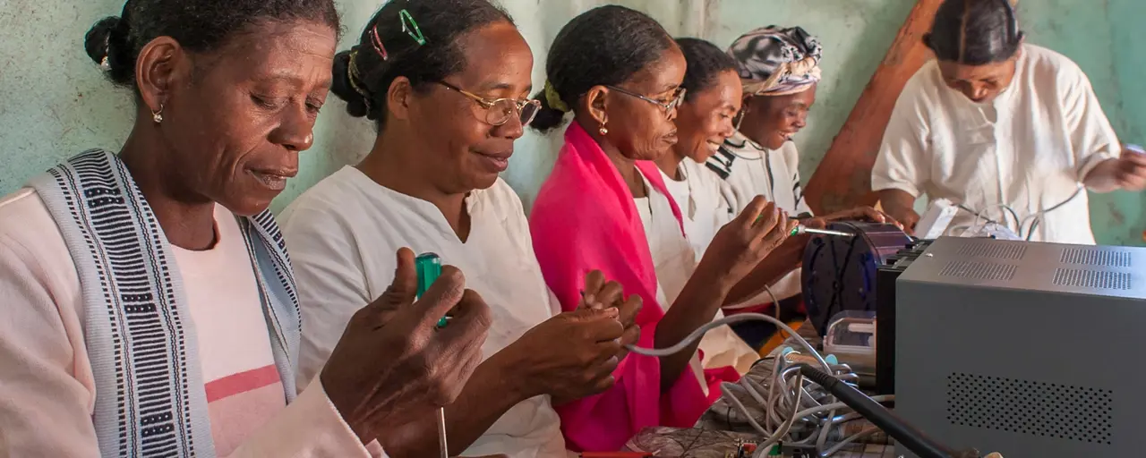 A group of six women working on solar technology