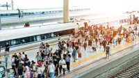 Crowd Of Passengers Waiting On Station Platform.