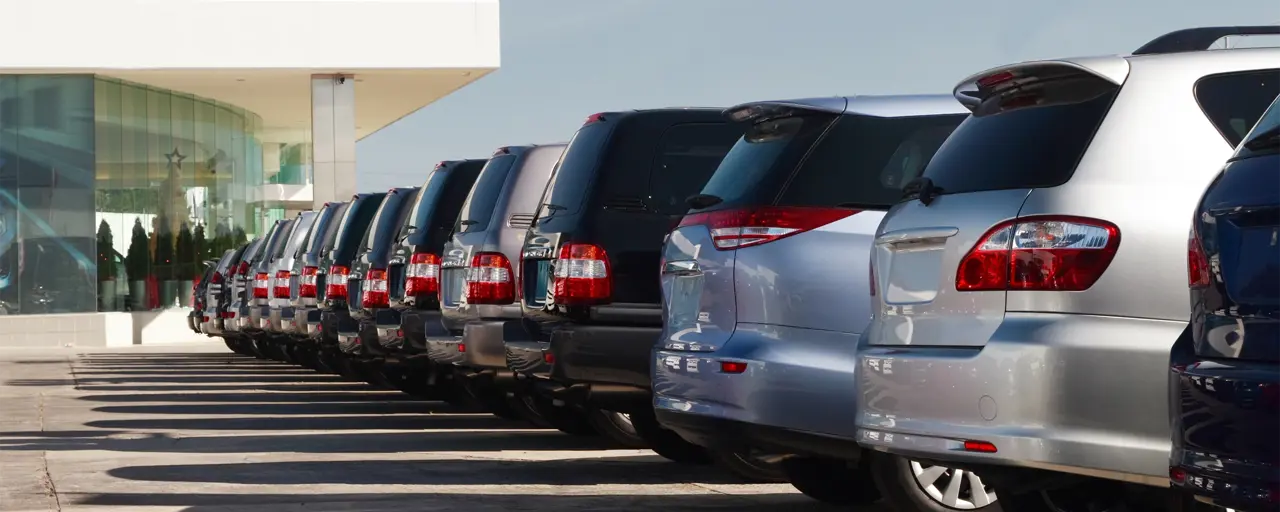 Cars parked up in a row in a car park, showing the back of the car.