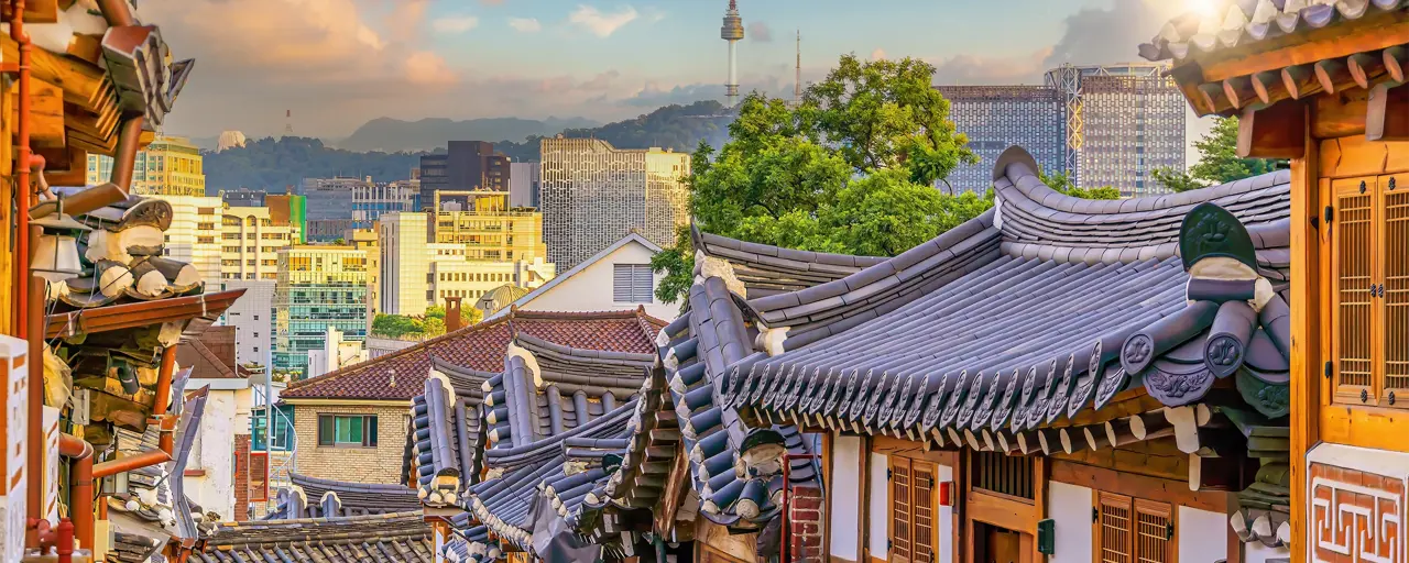 Bukchon Hanok Village with Seoul city skyline, cityscape of South Korea at sunset