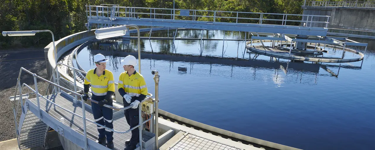 Water infrastructure and two men wearing high vis