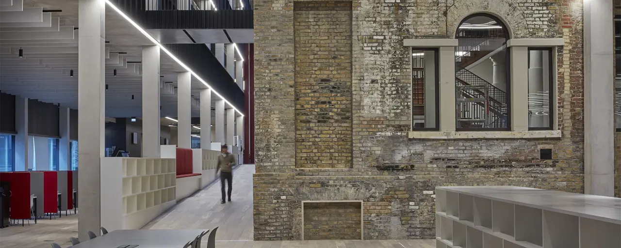 Interior shot of Tower Hamlets Town Hall with person walking down corridor.