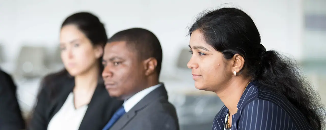 Group of three sitting and listening 