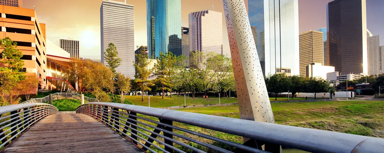 Collection of skyscrapers over a bridge at sunset