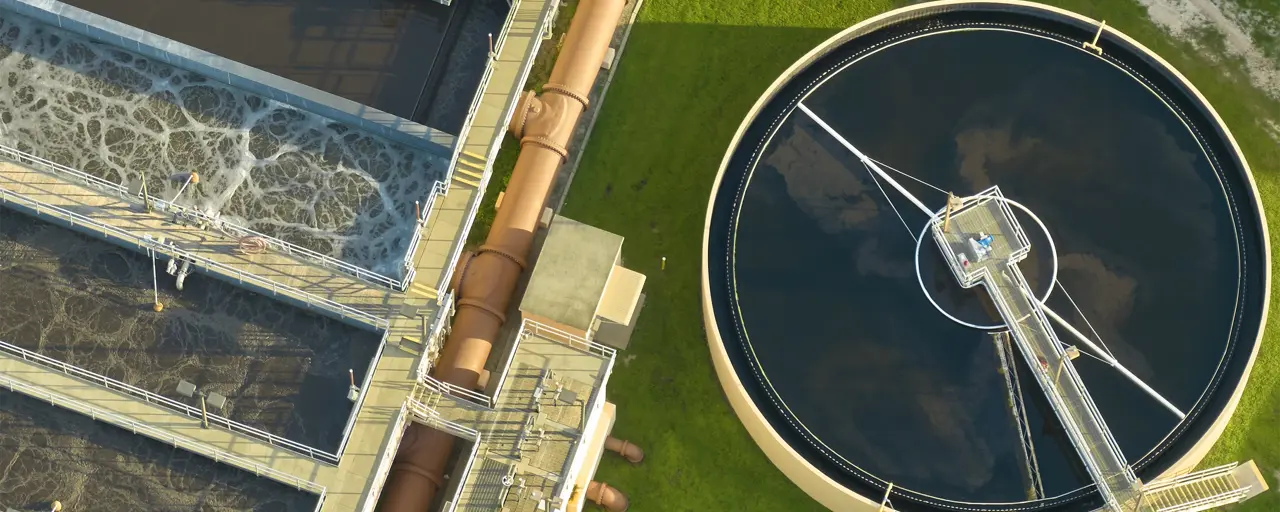 Aerial view of modern water cleaning facility at urban wastewater treatment plant. Purification process of removing undesirable chemicals, suspended solids and gases from contaminated liquid.